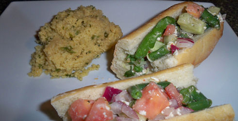 Greek Salad Baguette a great alternative to the deli meat sandwich.  I like to make this dish with a sourdough loaf or stuff the filling into large pitas.